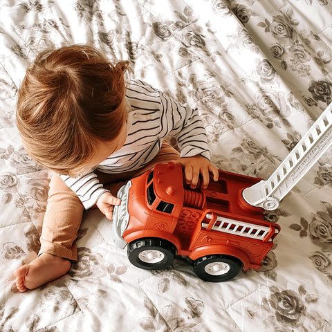 Toddler playing with their Green Toys Fire Truck Christmas gift