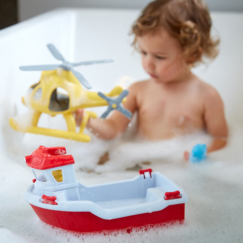 Girl playing with Rescue Boat and Helicopter in the bath