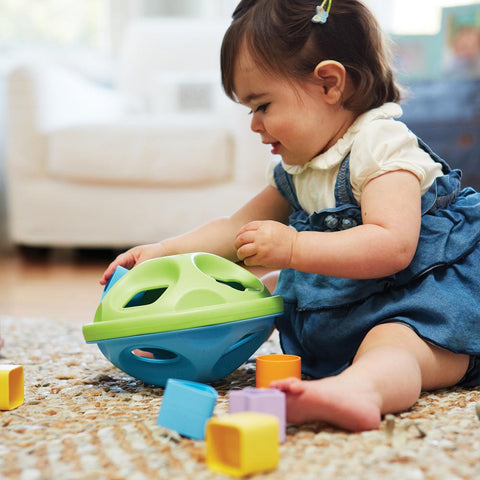 Eco friendly baby toys: girl playing with Green Toys Shape Sorter