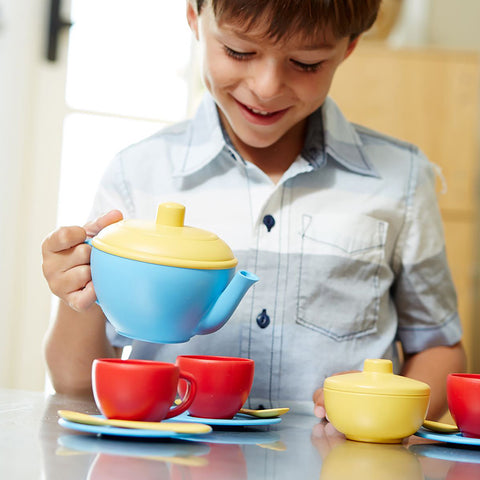 Boy using the pretend play teapot from Kids Tea Set 
