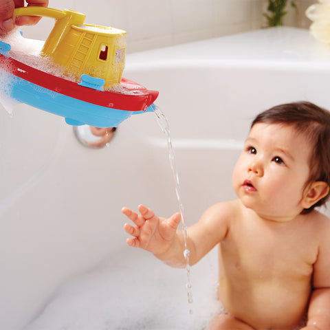 Eco baby gifts: boy playing with Green Toys Tugboat in the bath