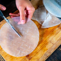 Cut rice paper rolls to make triangles for nachos with kopi thyme's recipe ideas.