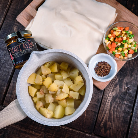 Ingredients to make samosas: frozen spring roll sheets, spices, boiled potatoes, frozen vegetables, Kopi Thyme's Kari Ayam Paste 