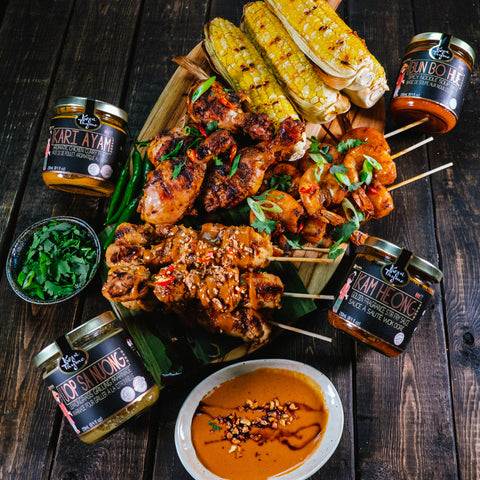 bbq platter, grilled corn on cob with bun bo hue butter, grilled shrimp with kam heong, grilled chicken with kari ayam and satay chicken peanut sauce with uop sa noung by kopi thyme
