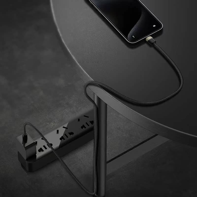 A-smartphone-being-charged-on-a-table-with-a-magnetic-charging-cable-that-neatly-wraps-around-the-table's-leg-due-to-its-magnetic-properties-showing-the-convenience-and-organization-it-provides
