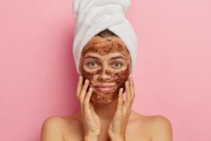 woman applying coffee face pack
