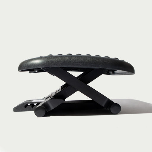 https://cdn.shopify.com/s/files/1/0631/1339/6473/products/Ergonomic-Black-Foot-Rest-Step_512x512.jpg?v=1675305626