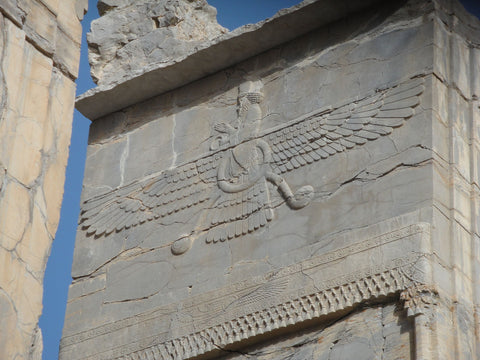 Stone carved Faravahar in Persepolis, Iran. Winged Sun symbol