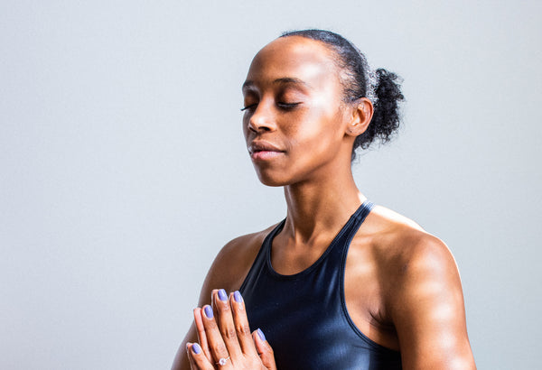 Woman breathing in meditation with prayer positioned hands