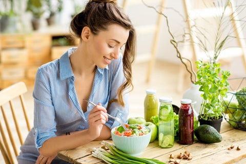 Woman eating a salad - Vitamin D Deficiency: Causes and Remedies