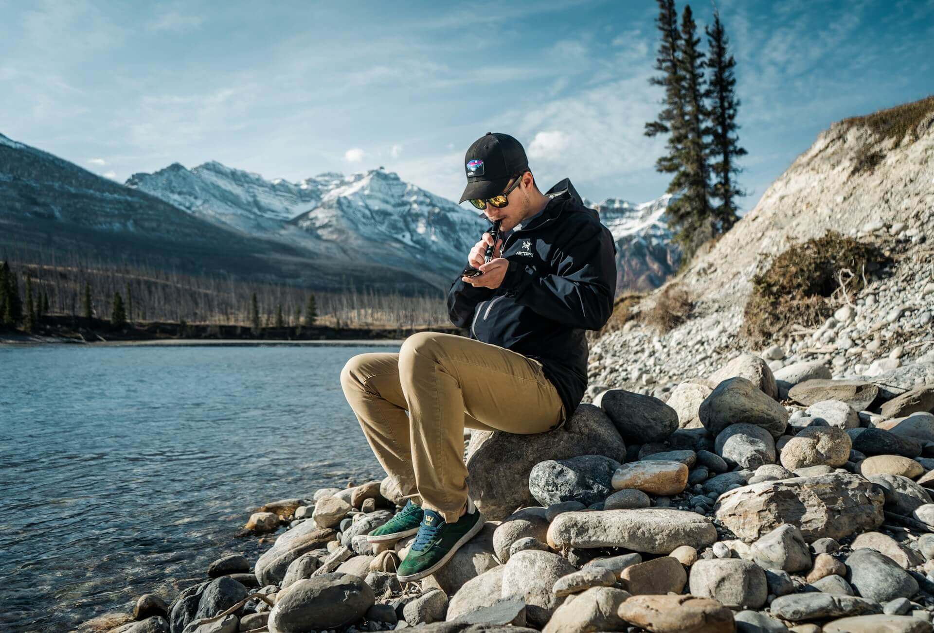 Person sitting on rocks using a nectar collector