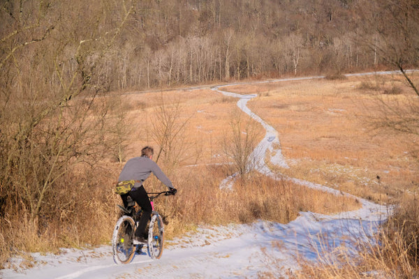 David rides snow covered road through winter field