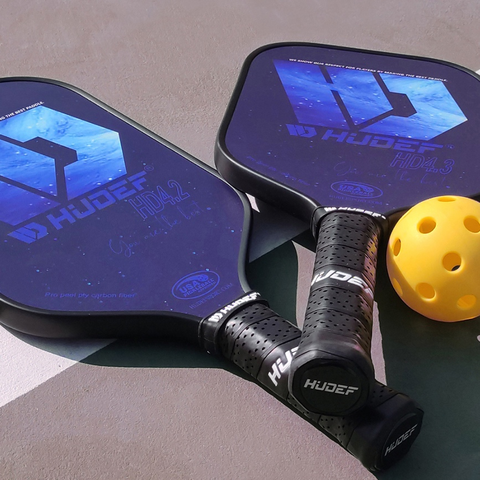pickleball paddles and a ball