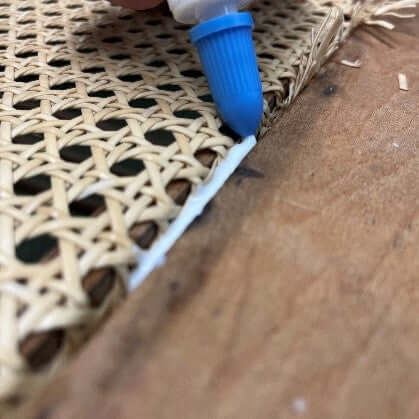 Filling the chair groove with non acrylic glue so that the cane webbing and Reed Spline can be glued into place.