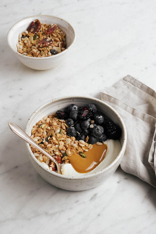 Yogurt bowl with original granola, protein power peanut butter and blueberries with kitchen cloth