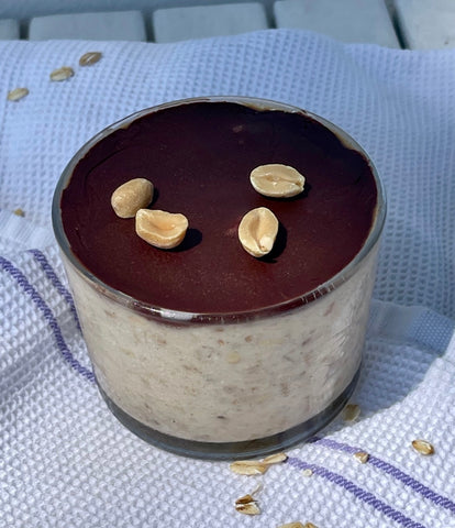 Bowl with overnight oat with snicker on kitchen cloth