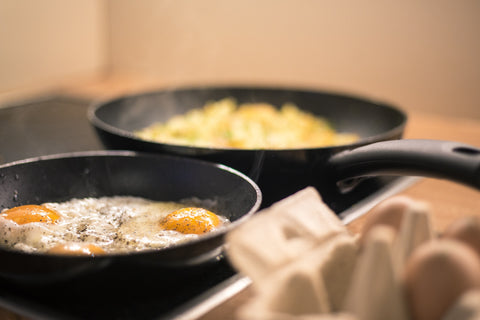 Pans with scrambled eggs and sunny side up