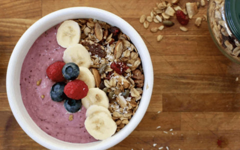 Smoothie bowl with banana, blueberries, raspberries and dried fruits