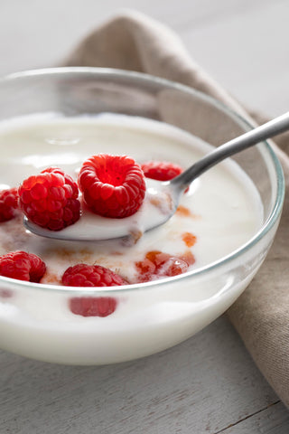 Bowl with yogurt and raspberries