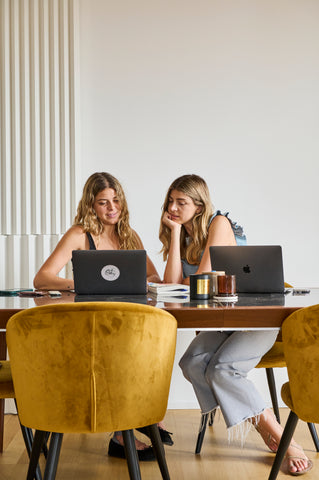 Two girls work on the computer