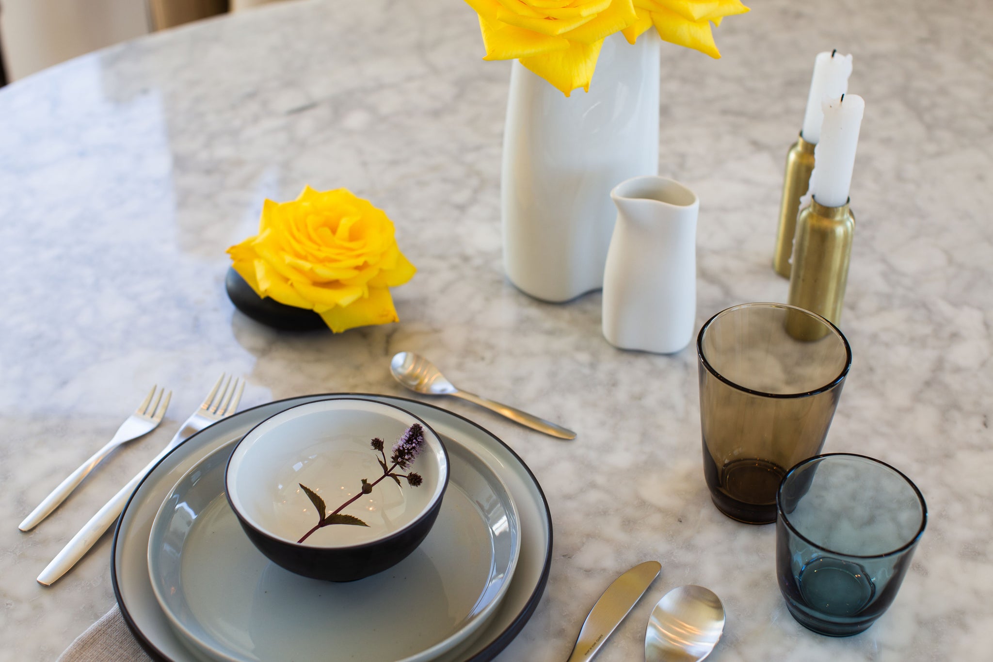 Arrangement of Kinto tableware and Cookplay jars on a casual dinner table