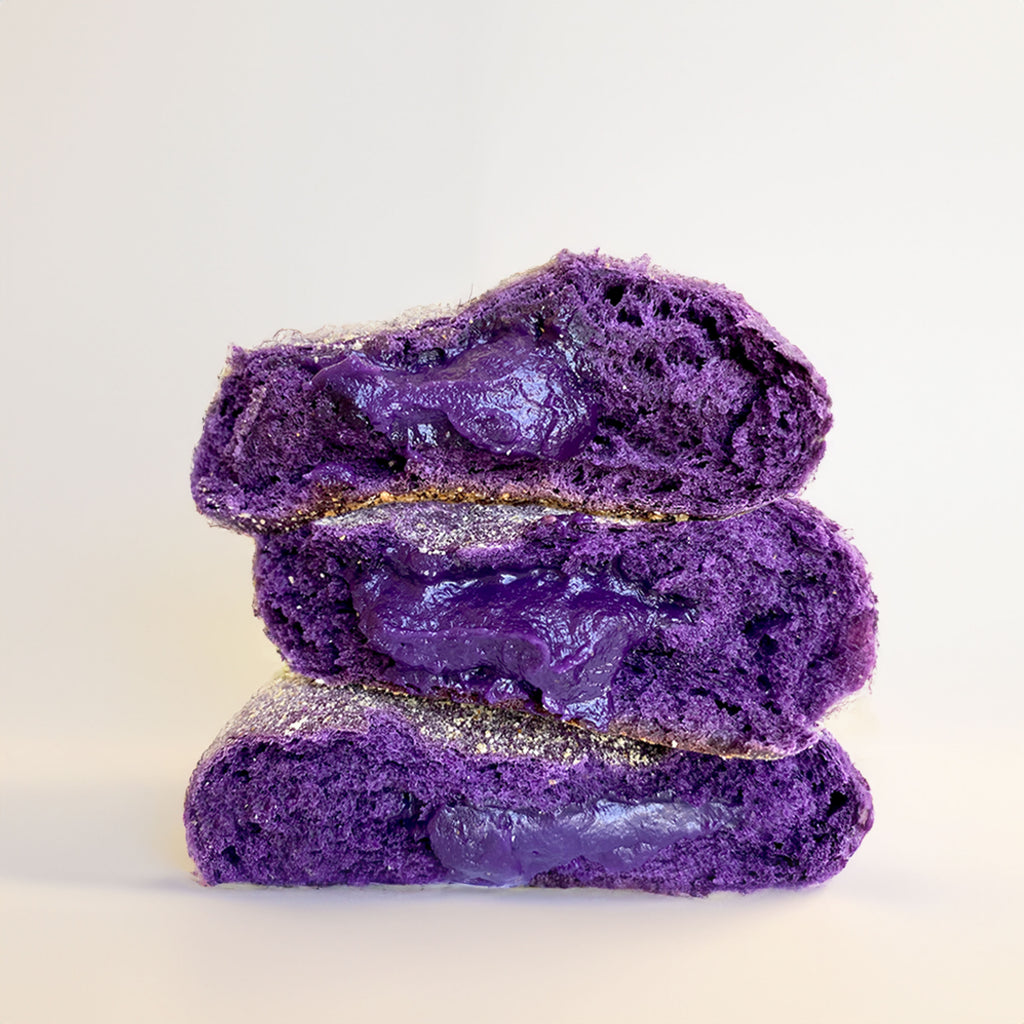 Stack of three Purple Buns (Bad Oven's ube pandesal) oozing with their homemade ube jam