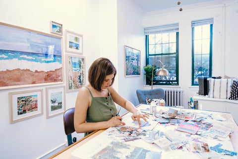 Catherine collaging with newspaper in her art studio.