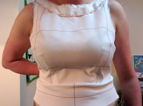 Front of the bodice. Already made a little adjustment to the neck which is now pinned in place, but the midriff and waist areas still don’t fit right.