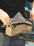 Kevin prepares a custom Gouache Otto Rider bag featuring Filipino woven fabric to attach to his bike prior to a ride.