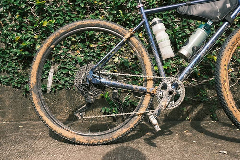 Photo of a muddy bicycle focusing on the Microshift XLE Drivetrain the writer purchased at Tambay Cycling Hub.