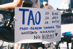 A sign saying "TAO sa bike, sa jeep, sa motor: pare-pareho tayong tao. Gustong nakauwi ng buhay" (Humans on bike, on jeep, in car, we're all the same. We want to get home alive). Tal, our team member's sign during the protest.