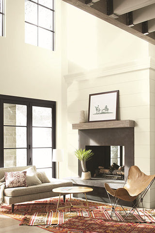 living room with high ceilings, a couch, and a fireplace