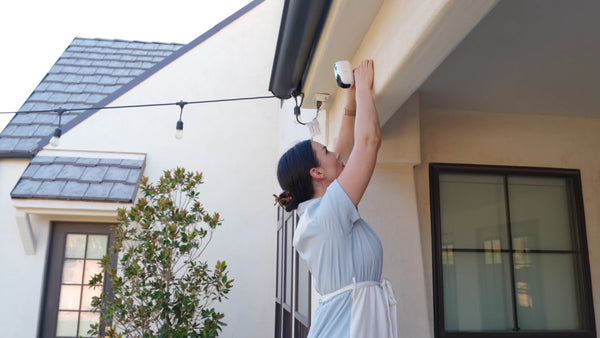 Female home owner install the outdoor camera system wireless