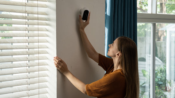 A girl installing WUUK Home Security Cameras