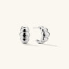 Puffy Charlotte Hoops: A pair of bold, silver earrings from the Charlotte Collection, designed for making a statement.