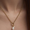 Woman wearing Organic Pearl Charm necklace with a pearl and diamond pendant.