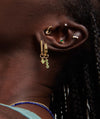 Diamond Mini Studs on a woman's ear, showcasing the minimal yet bold design with 14k solid gold and 0.06 carat diamonds.