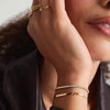 Close-up of a woman's hand wearing the Lab Grown Diamond Tennis Bracelet 1.8mm, showcasing its elegant 14k solid gold and sparkling lab-grown diamonds.