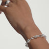 Hand wearing the Mejuri Custom Chain Bracelet, a unique, customizable silver piece designed for adding charms and personal touches.