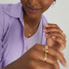 Paperclip Chain Charm Necklace with a gold clasp, worn by a woman in a purple shirt, showcasing its versatile, handcrafted 14k recycled gold design.