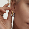 Close-up of a woman's ear wearing Stevie Hoop Links, showcasing the elegant, interchangeable, and reversible design for versatile styling options.