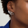 Close-up of a woman's ear wearing Bold Small Hoops, showcasing elegant, outfit-elevating hoop earrings.