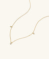 Trio Diamond Necklace: A 14k gold choker with three diamonds, handcrafted for a dainty yet edgy look.