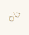 Huggie U Hoops: A pair of handcrafted 14k solid gold earrings with responsibly sourced diamonds, featuring a unique U-shaped design.