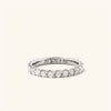 Bold Diamond Eternity Ring: a close-up of a handcrafted 14k gold ring featuring 23 round brilliant cut diamonds set in open prongs.