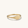 Signet Ring: A close-up of a handcrafted 14k gold ring with a round center, ideal for engraving initials.