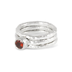 Handmade stacking silver rings set with a garnet.
