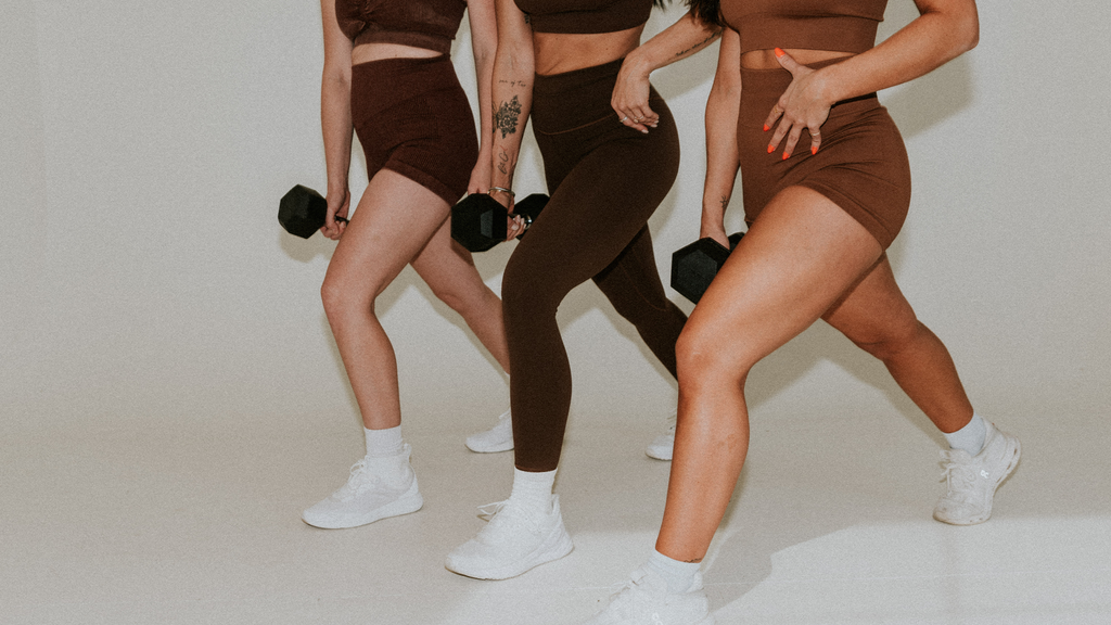 Three women posing while exercising