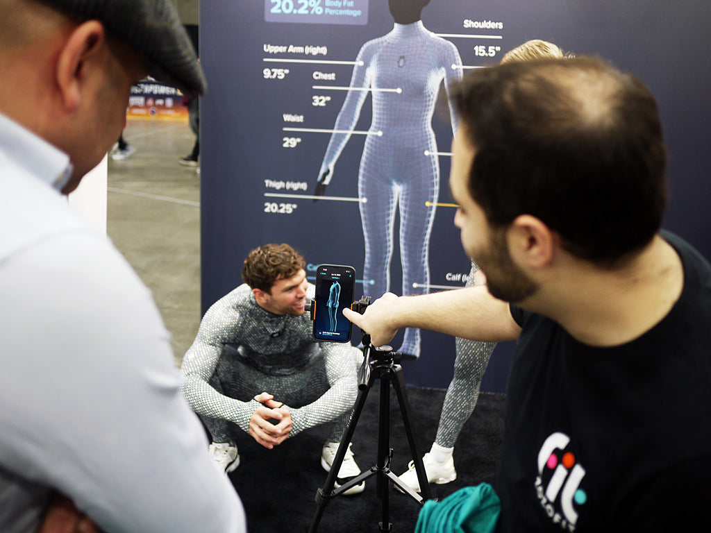 ZOZOFIT shows a FITEXPO attendee how the app works.