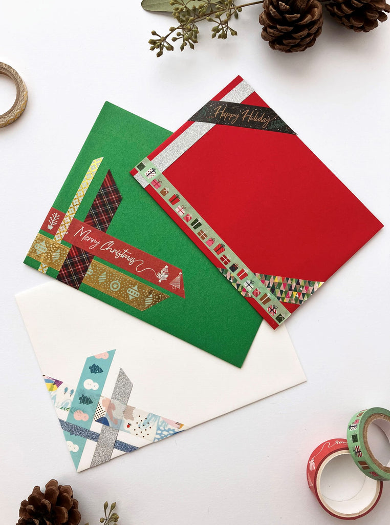 White, green, and red envelope decorated with washi tape